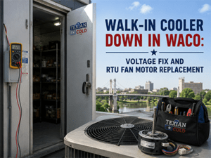 Technician inspecting a commercial walk-in cooler condenser at a Waco, TX facility