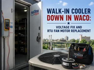 Technician inspecting a commercial walk-in cooler condenser at a Waco, TX facility