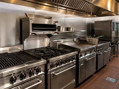 Technician servicing hot-side cooking equipment in a Whitney, TX commercial kitchen
