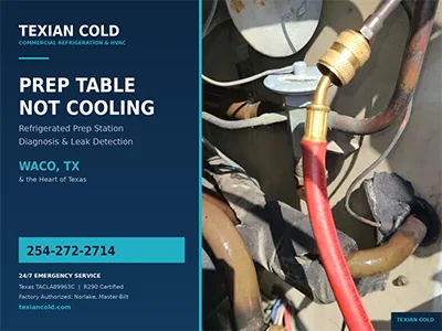 Refrigeration gauge hoses connected to a commercial prep table condensing unit during a leak check in Waco, TX