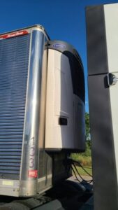 What happens when a refrigerated truck gets a leak. A quick roadside topoff to get them home.
